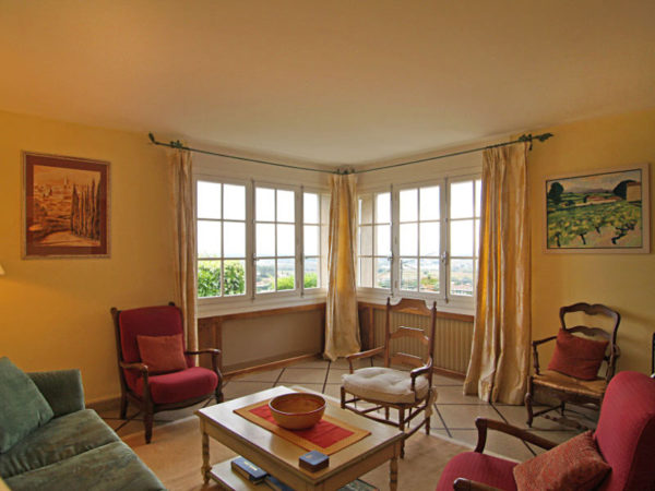 Просторная гостиная с креслами и легкими шторами